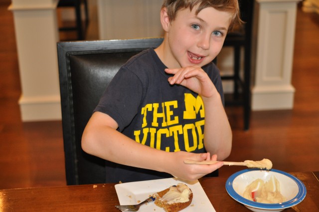 Photo of a young Katzman frosting a piece of carrot cake