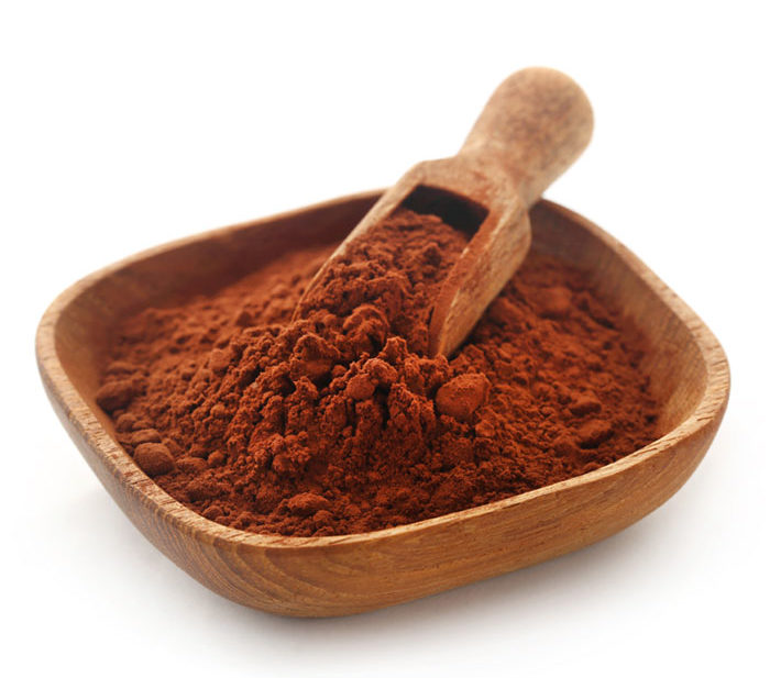 Photo of cocoa powder in wooden bowl